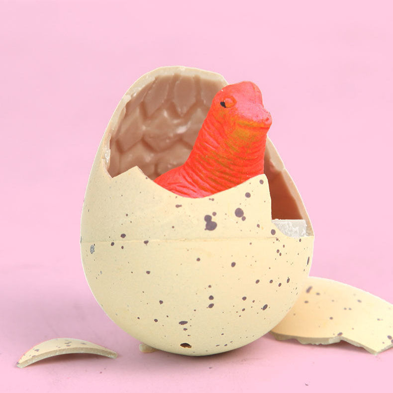 Party favor toy resembling an egg with a red creature inside on a pink background, text indicating it&#39;s like Easter eggs and breaking it open is a surprise.