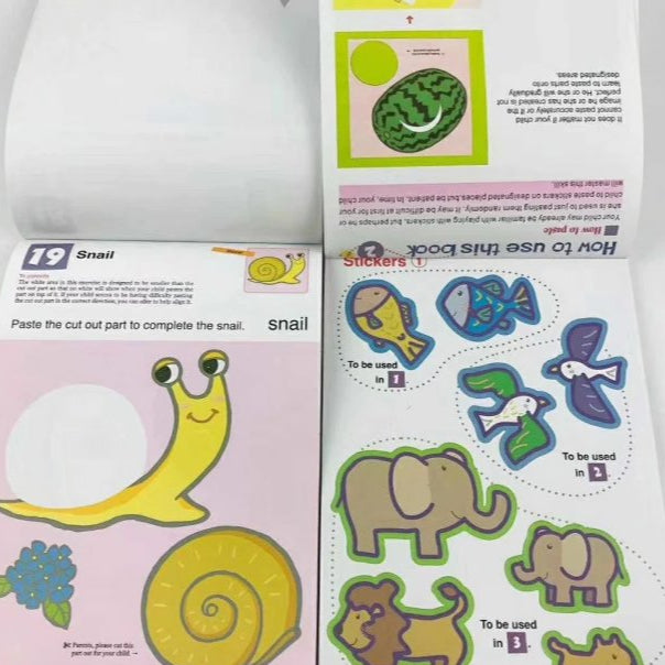 Kumon First Steps Activity Workbook pages with colorful sticker, cutting, and pasting activities for toddlers.