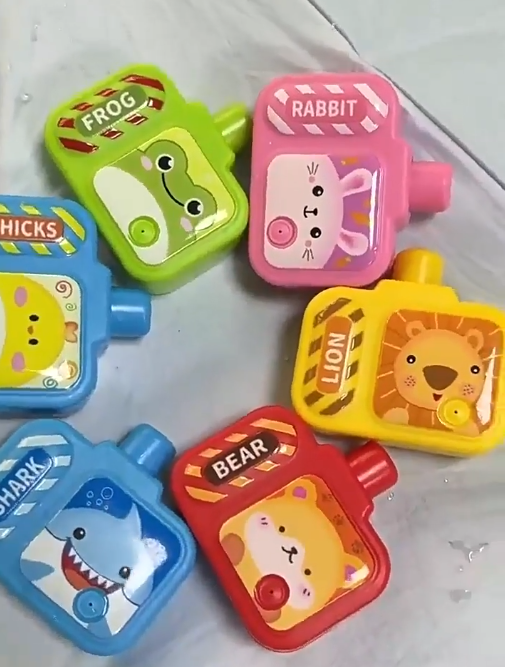 Colorful mini camera-shaped water guns with animal designs including frog, rabbit, lion, bear, shark, and chick for kids&#39; party favors and gifts