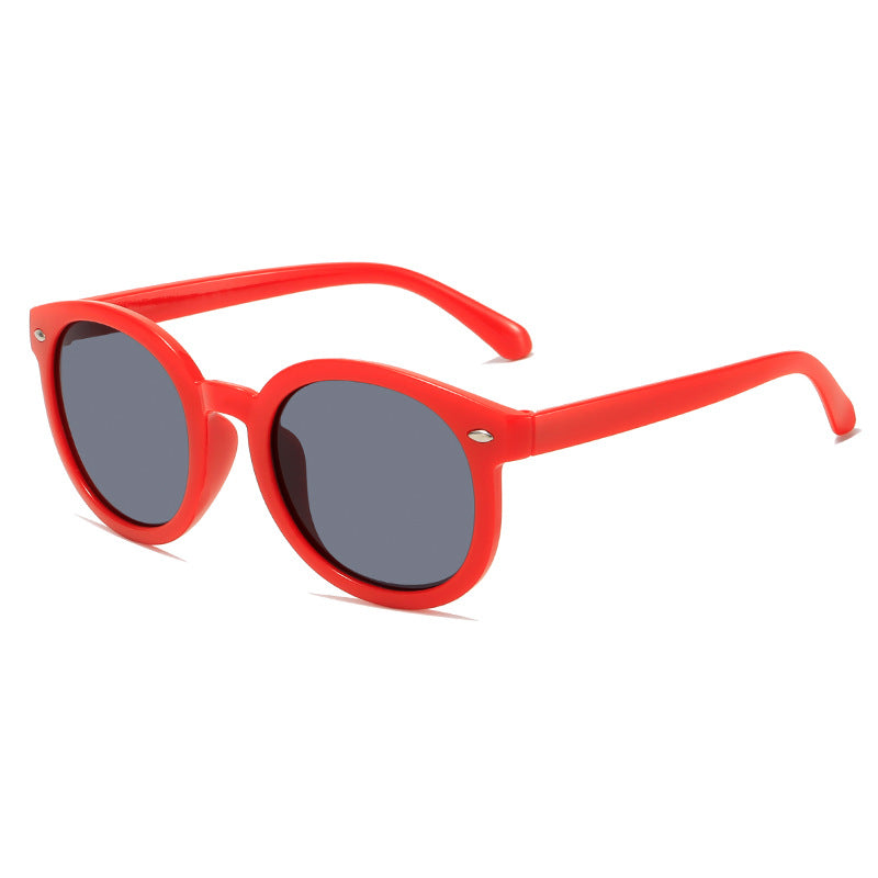 Red kids sunglasses with round black lenses, lightweight and stylish for parties and play