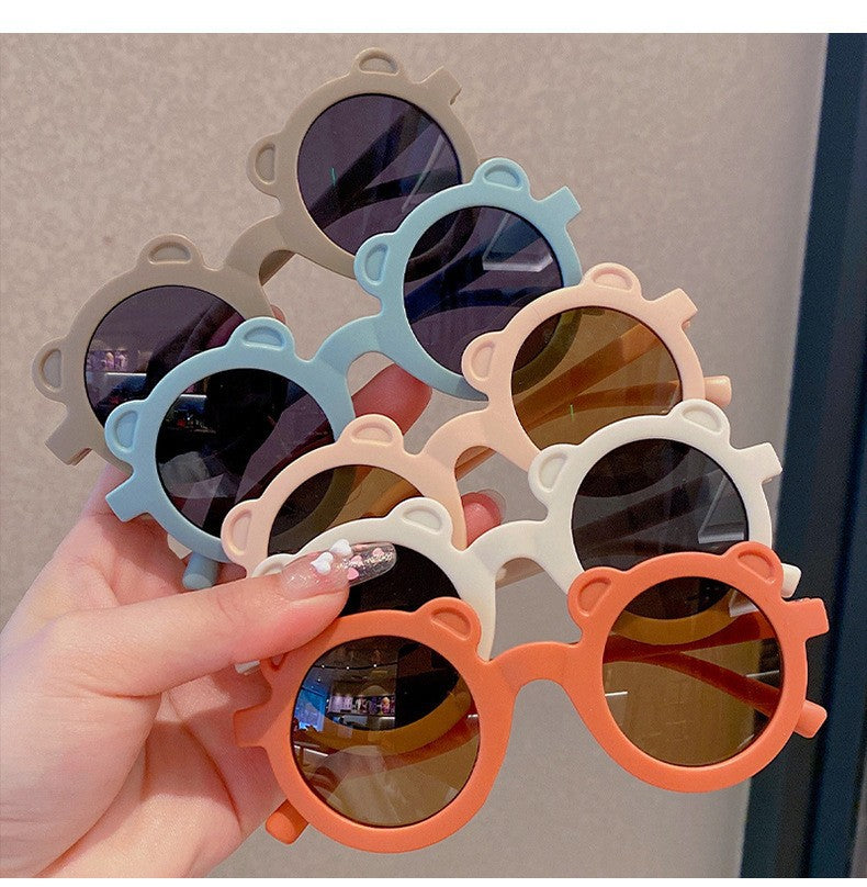 Kids sunglasses with bear-shaped frames in assorted colors.