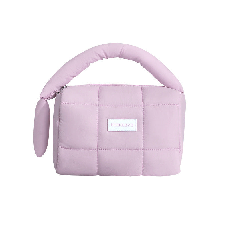 Quilted puffer travel pouch in pastel colors for organizing essentials