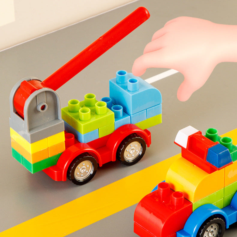 Colorful toy building block cars with a hand interacting, on a neutral background.