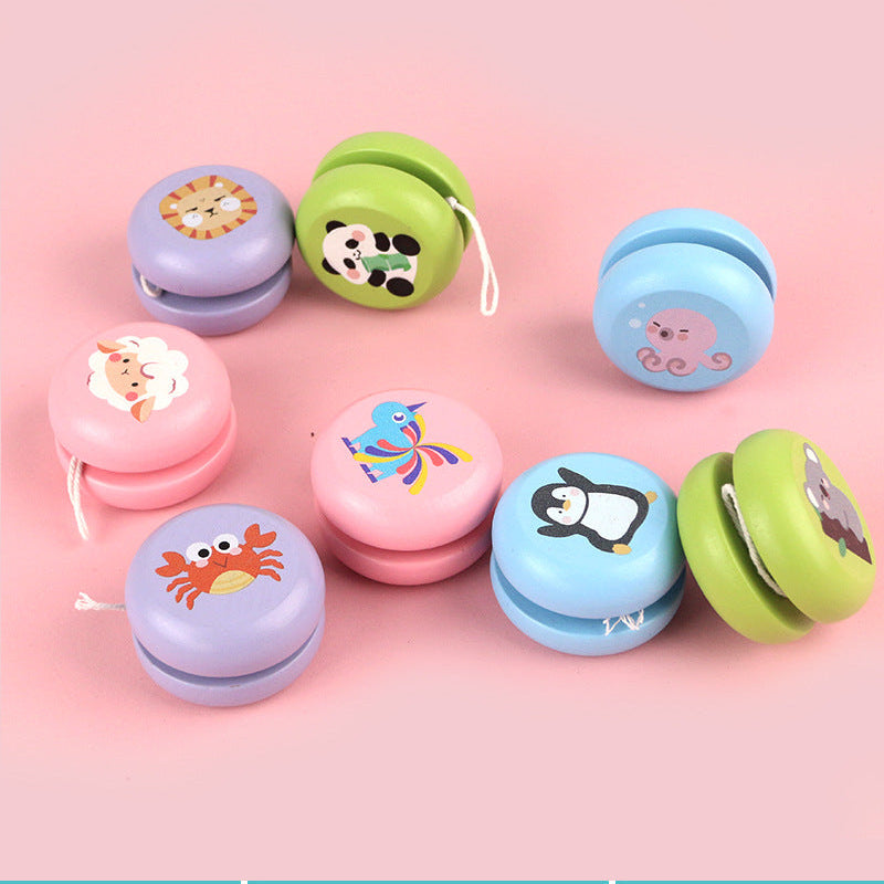 Colorful wooden yoyo with animal designs including panda, crab, and unicorn on a pink background.