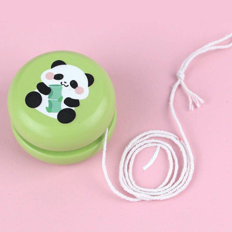 Colorful wooden yoyo with panda design on pink background.